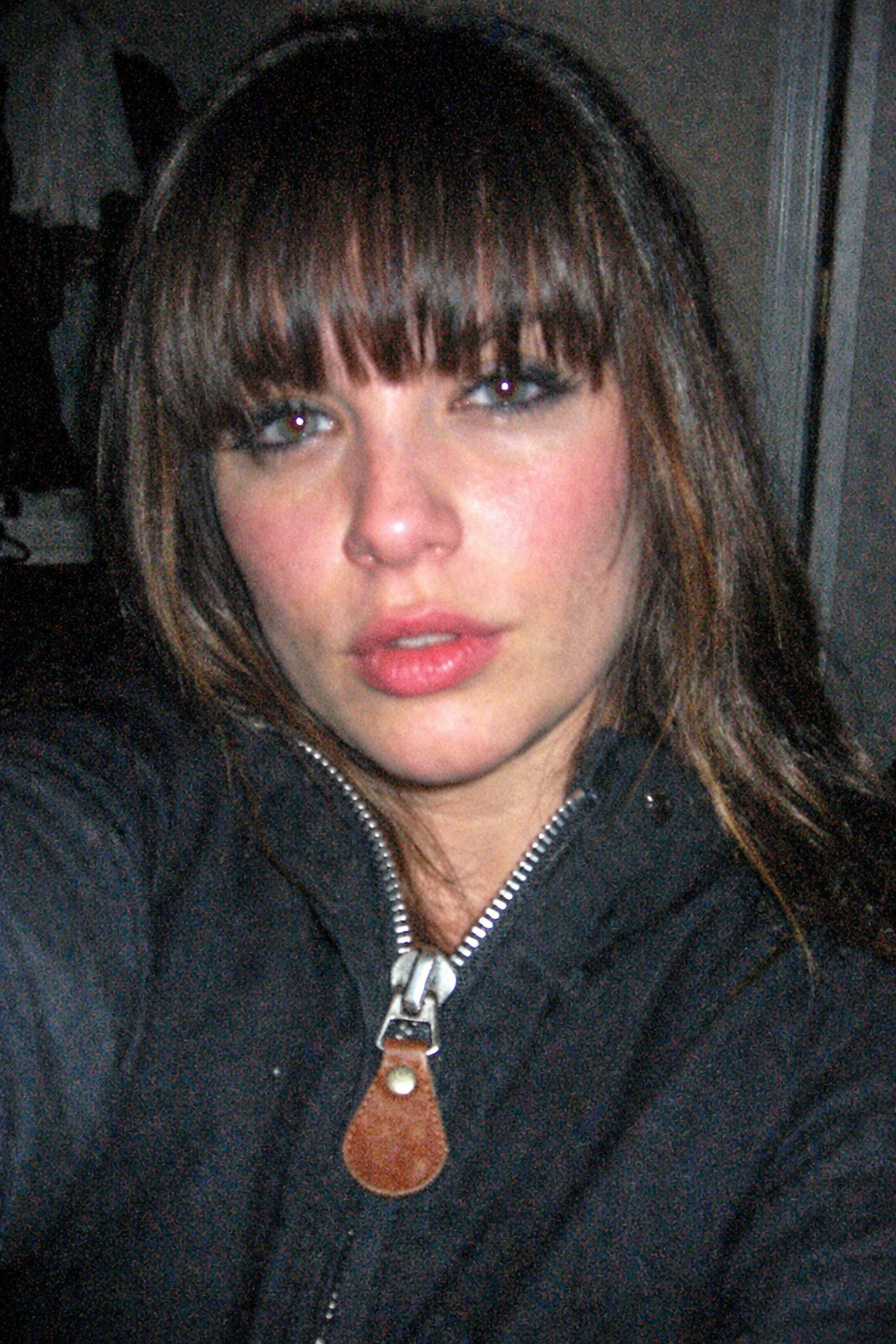 A night-shot photograph of a female model American with thick bangs. POV perspe...