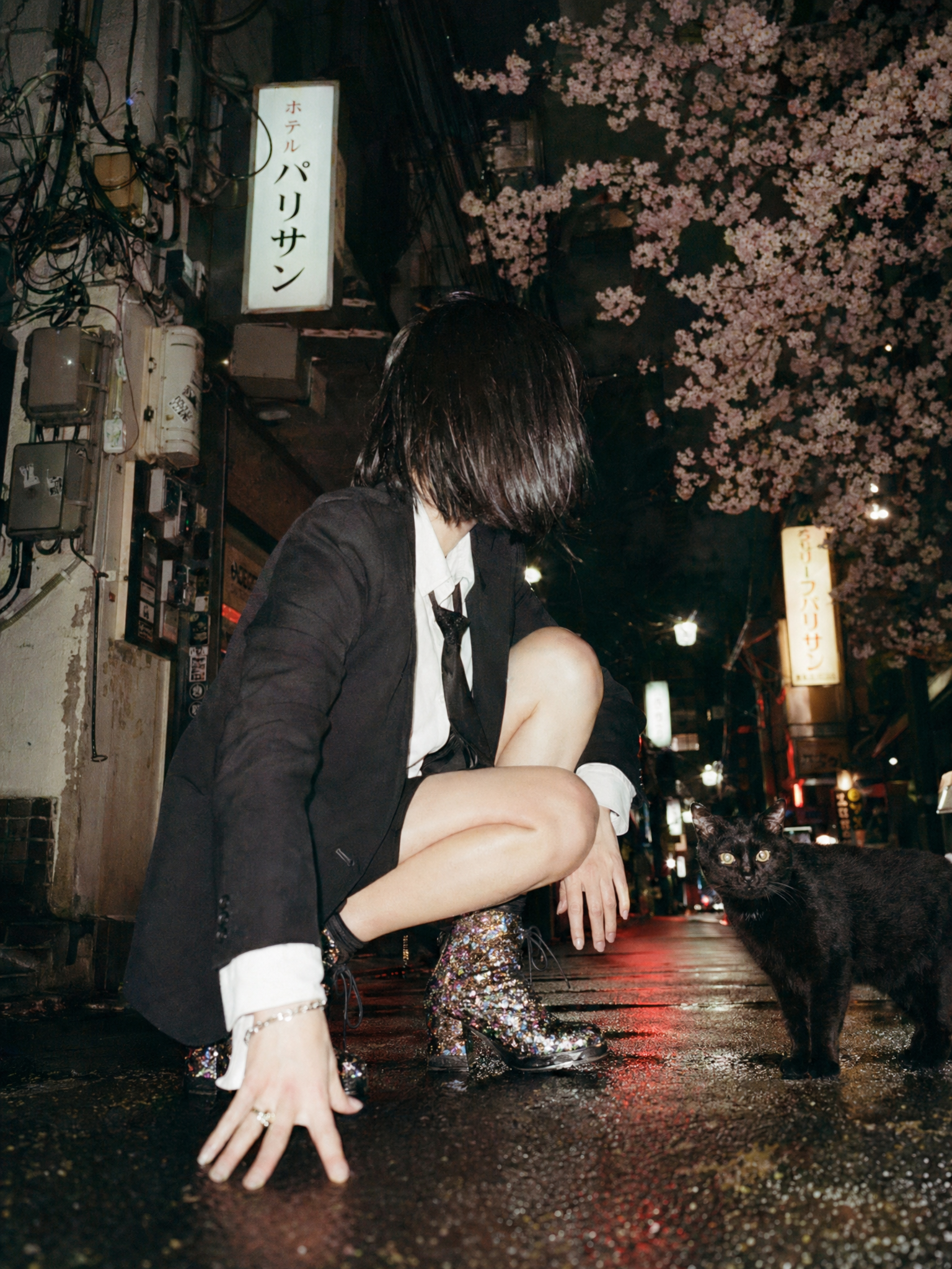 A cinematic candid night street photo in Tokyo shot from an extremely low groun...